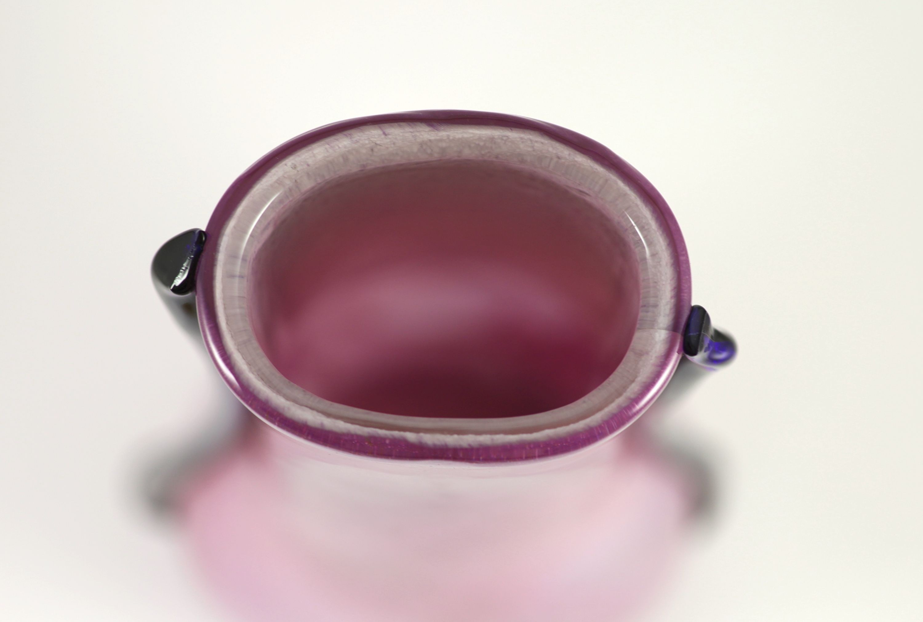 Elizabeth Graydon-Stannus, an unusual mottled pink and purple glass vase, circa 1930, of flattened pear form with applied blue lug handles, etched 'Gray-Stan' to base 44cm high